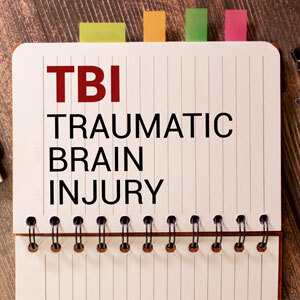 Medical Concept of Traumatic Brain Injury (TBI) on Notebook